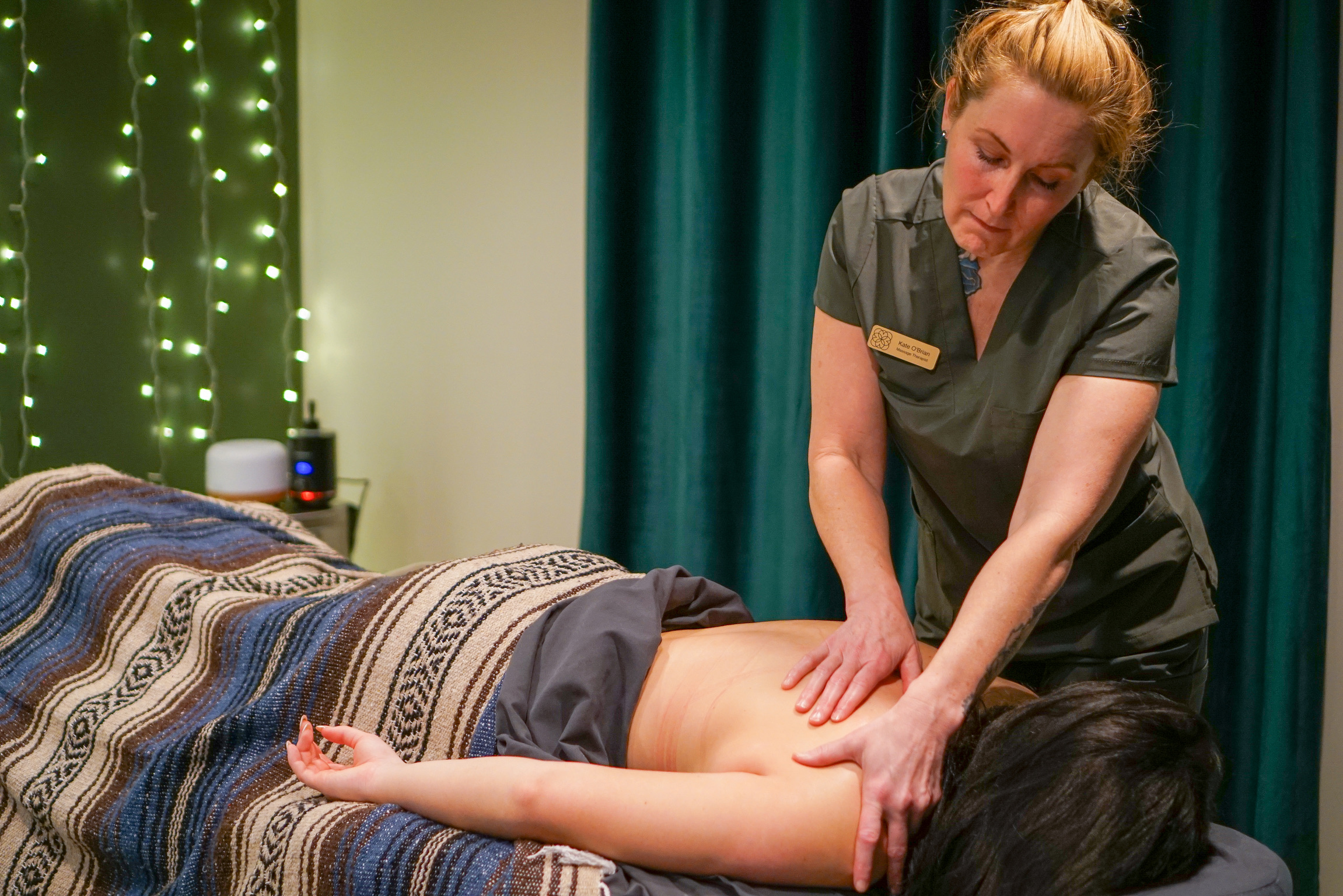 Therapeutic massage at Bodhi Salt Center with fairy lights and green curtain