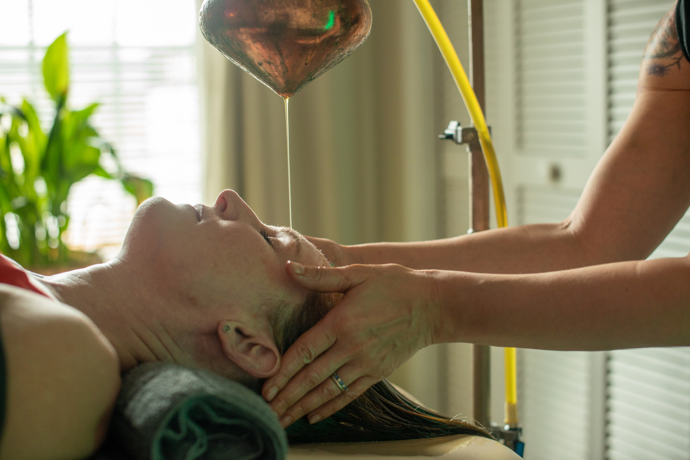 Shirodhara treatment at Bodhi Salt Center — warm oil stream with practitioner hands