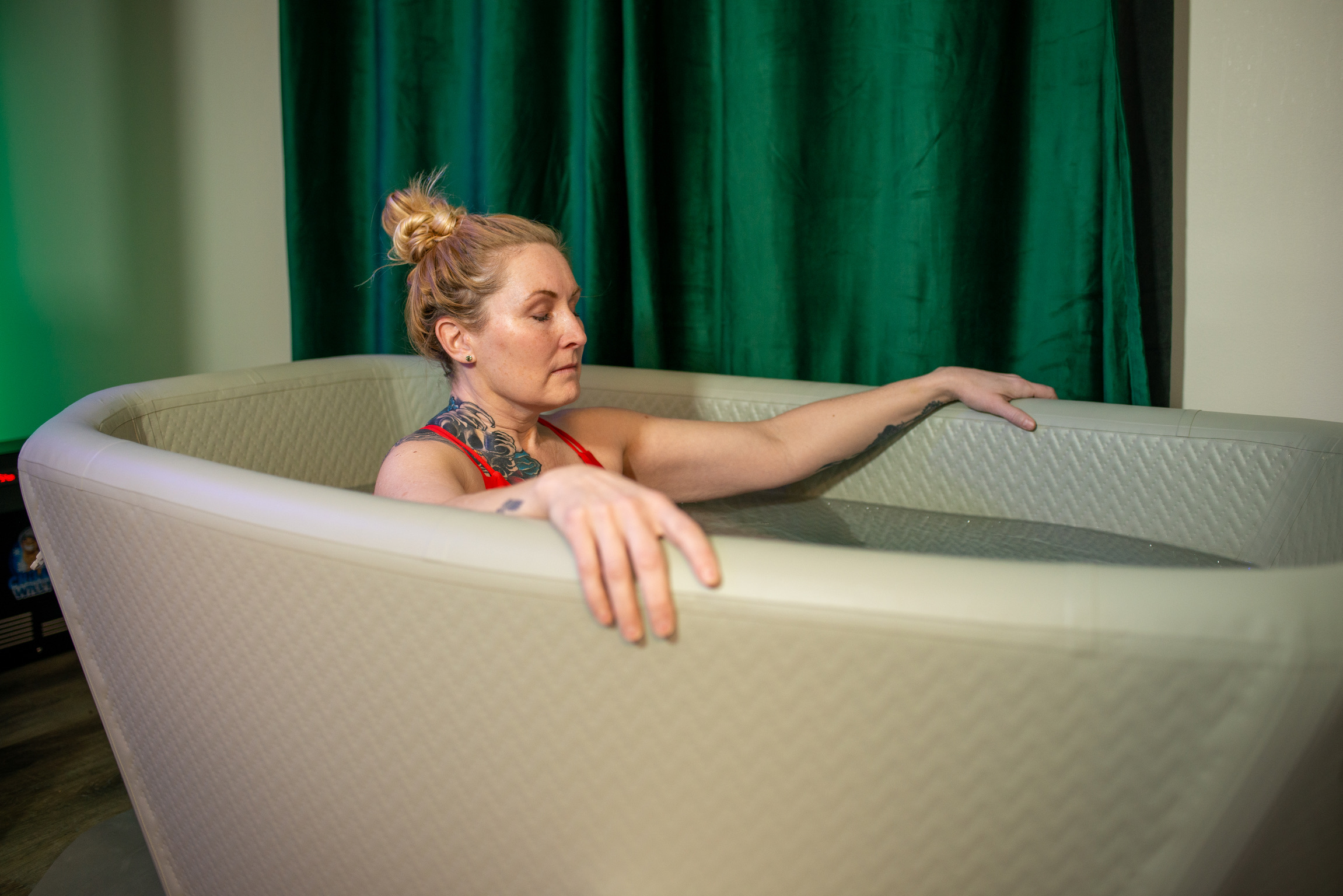 Woman in cold plunge during contrast therapy at Bodhi Salt Center